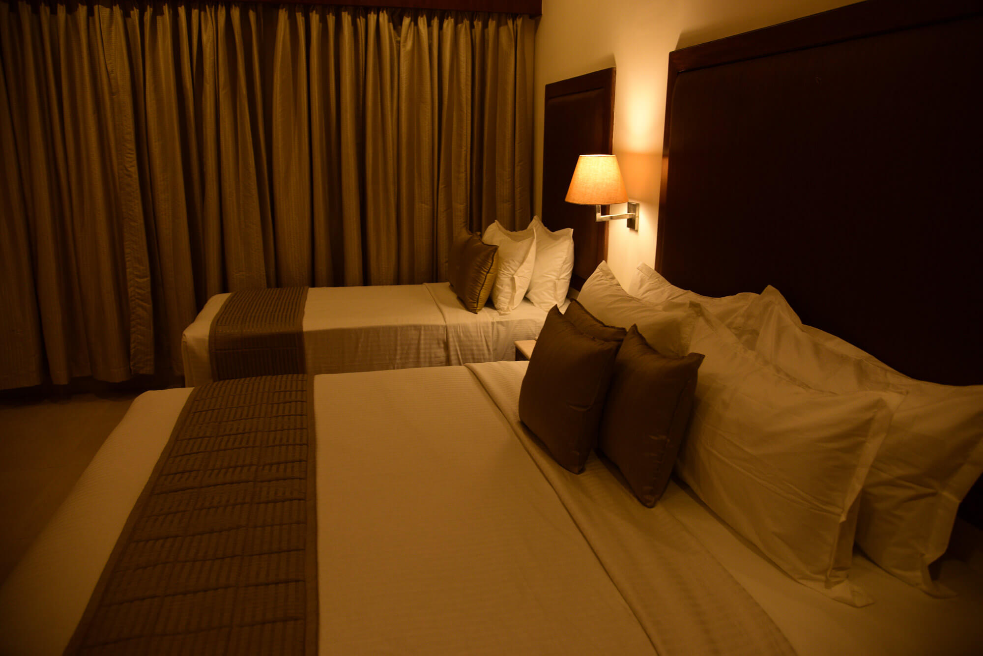 Triple bedroom with brown shade in Hotel Rameswaram Grand